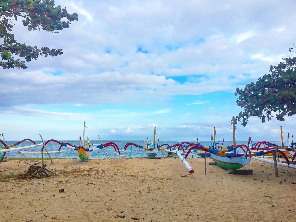 057FA838-811F-42EE-978F-921B92721F3B_1_105_c Small boats along the shore of Bali, Indonesia.
