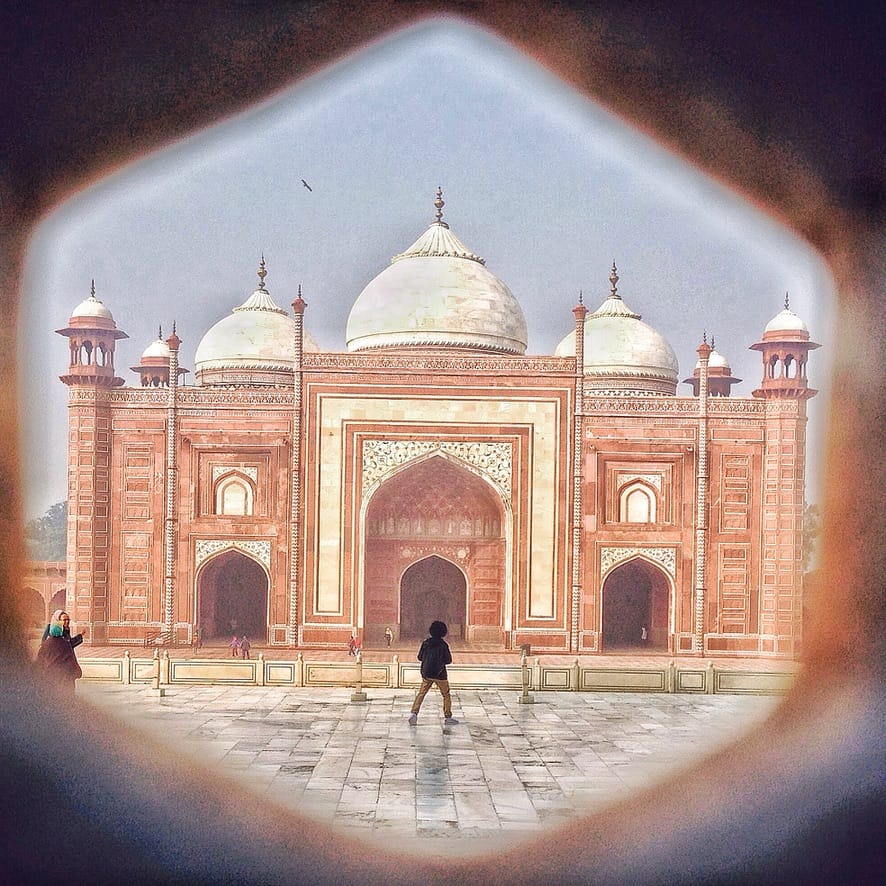 F734C592-B2AF-4695-88ED-052588A545A8_1_105_c View of the Taj Mahal through wall.